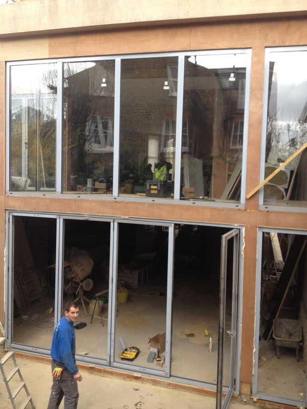 Aluminium bi-fold doors with two-storey glazing in Cobham