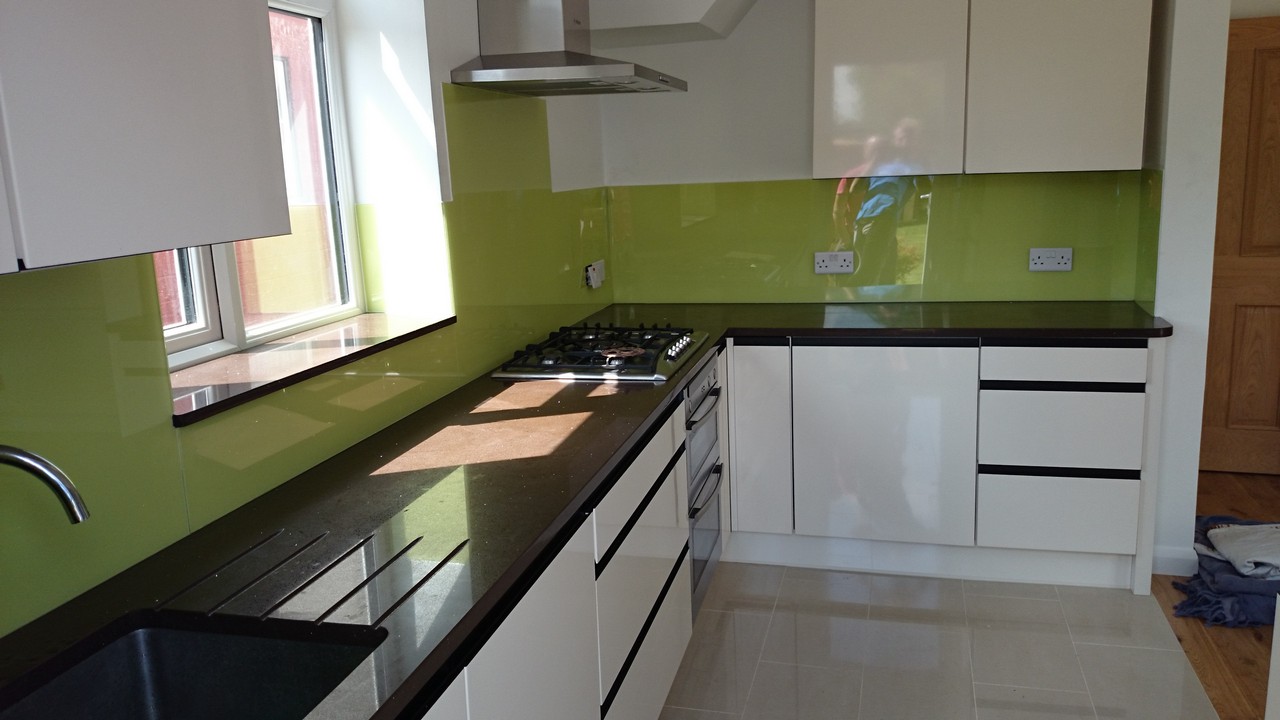 Lime green glass kitchen splashback installed by Cobham glaziers